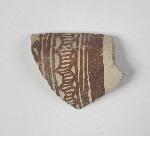 Shard of greenish pottery with brown decoration