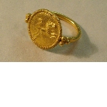 Ring with disc-shaped bezel and lion engraving
